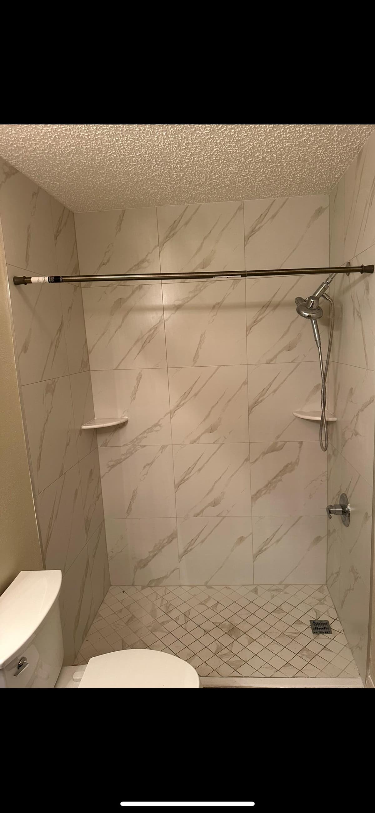 Luxury bathroom with marble-look tile and mosaic flooring