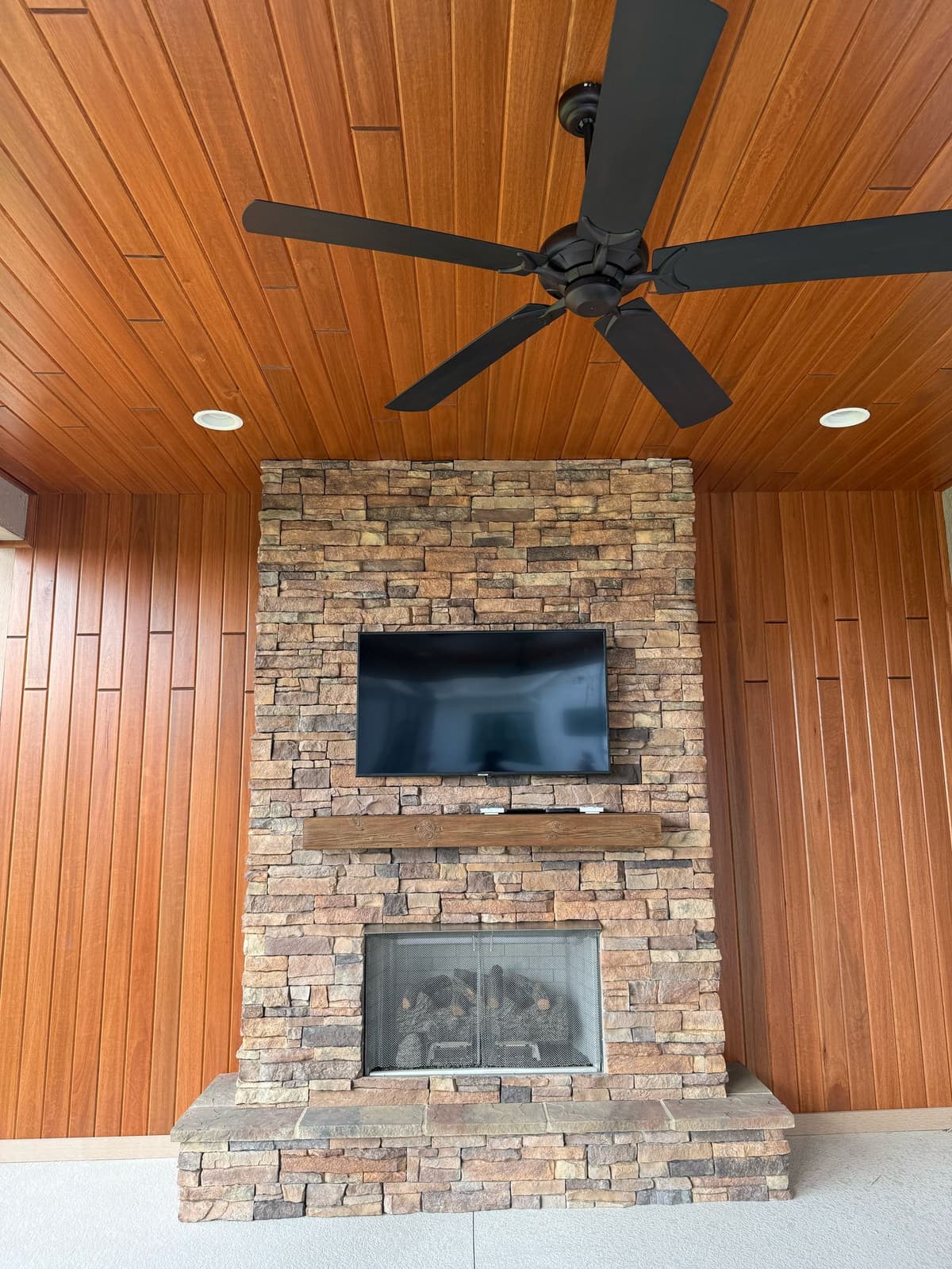 Outdoor patio with TV and fireplace